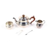 A silver round three piece tea set.