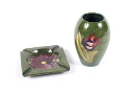 A Moorcroft green-ground vase and an ashtray.