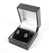 A pair of vintage white gold, ruby and diamond oval cluster stud earrings.