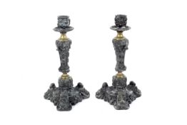 A pair of Victorian brass and spelter candlesticks.
