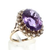 A 9ct gold amethyst and half-pearl oval cluster ring.