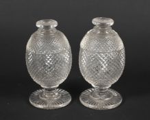 A pair of Regency cut glass sweetmeat jars and domed covers.