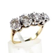 A mid-20th century gold diamond four stone ring. The early modern round brilliants approx 0.