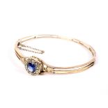 An Edwardian rose gold, sapphire and diamond cluster bangle.