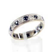 A 9ct gold, black sapphire and tiny eight-cut diamond eternity ring.