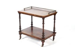 A Victorian brass-mounted rosewood two-tier tea table/trolley.
