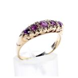 A vintage 9ct gold and ruby five stone cast 'carved half-hoop' ring in late Victorian style.