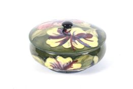 A Moorcroft green ground circular bowl and cover in the hibiscus pattern.