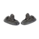 A pair of bronze models of lions on black marble bases after Barnie.