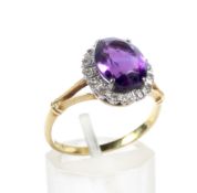 A vintage gold, amethyst and diamond oval cluster ring.