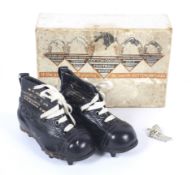 A pair of souvenier Cotton Oxford rugby boots and metal New Zealand pin badge.
