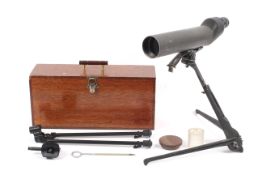 A shooting telescope complete with tripod, in wooden case.