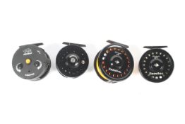 Four modern trout fly reels.