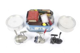 A collection of vintage fishing tackle. Including reels, bait tins and assorted accessories.