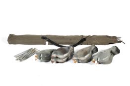 Camouflage netting and 33 clay pigeon decoys with mounting sticks.