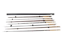 A collection of seven carbon, glass and graphite fly rods.
