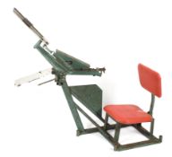 A portable Bowman manual clay trap with seat and back rest.