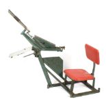 A portable Bowman manual clay trap with seat and back rest.