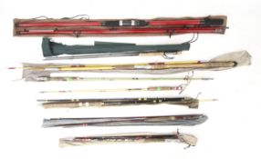 A mixed selection of fishing rods. Including a beach caster, spinning and coarse fishing rods.