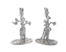 Two W W Harrison & Co pewter spill vase bases showing cricketers in front of trees.