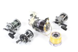 A collection of four fishing reels.