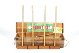 A John Jacques croquet set in box. Comprising four mallets, hoops, balls and instructions, etc.