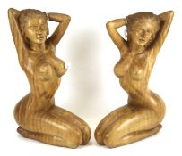 Two carved wooden sculptures of women.