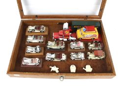A wooden table top display case with diecast vehicles.