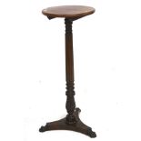 A Victorian rosewood and mahogany torchiere stand.