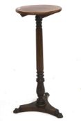 A Victorian rosewood and mahogany torchiere stand.