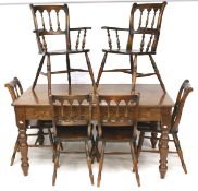 A rectangular stained pine kitchen dining table and six chairs.