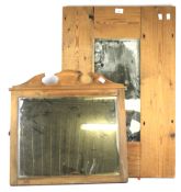Two wooden framed wall mirrors.
