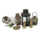 A large assortment of oil lamps and lanterns.