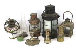 A large assortment of oil lamps and lanterns.