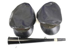 A British Railways horn and two vintage caps. The horn by ACME, L38cm, both black leather caps by J.