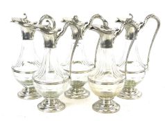 A set of five Etains du Manoir claret jugs.