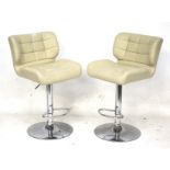 A pair of 20th century adjustable stools. With cream leather seats and chrome stands, Max.