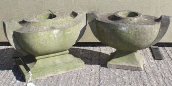 Two composite stone carved grave urns.