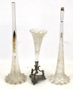 Three Victorian glass trumpet vases. One has a silver plated tripod base. Max.