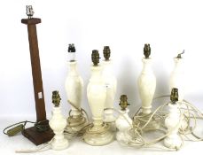 Eight 20th century alabaster lamp bases and a wooden example.