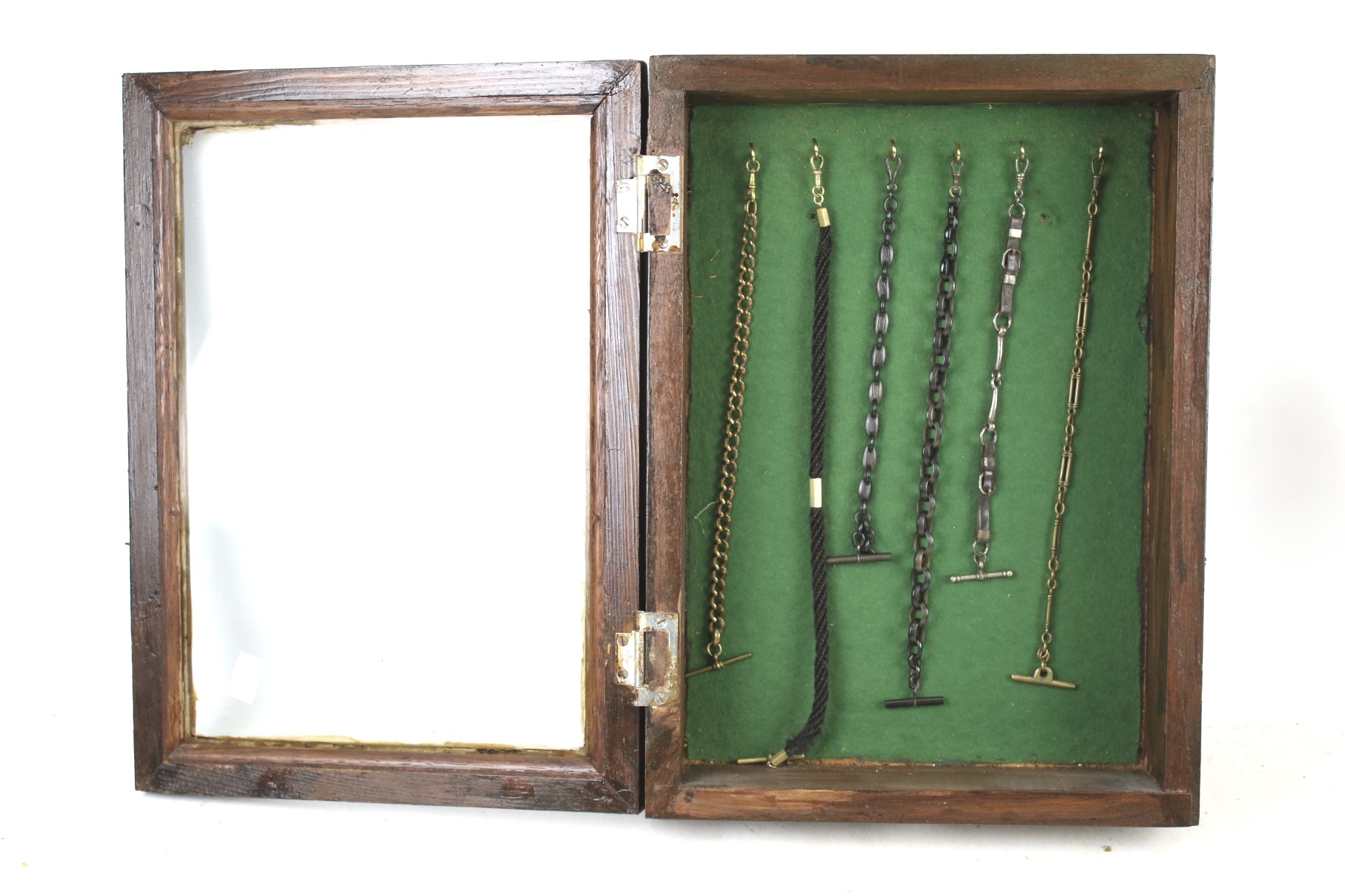A display case with six assorted vintage watch chains. L29.