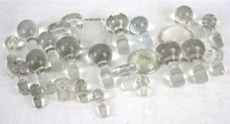 A collection of assorted glass decanter stoppers.