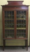 An Edwardian mahogany and leaded glass display cabinet.
