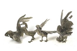 Two pairs of cast metal bird ornaments.