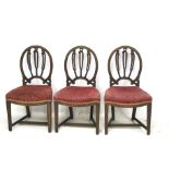 Three Edwardian mahogany framed red upholstered dining chairs.