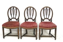 Three Edwardian mahogany framed red upholstered dining chairs.
