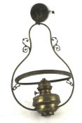 A vintage brass oil lamp converted into a ceiling light. H60cm.