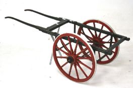 A vintage carved wooden dog cart.