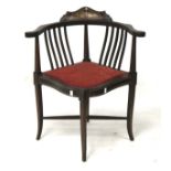 An Edwardian mahogany corner chair.