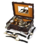 A jewellery box containing an assortment of ladies and gentleman's wristwatches.